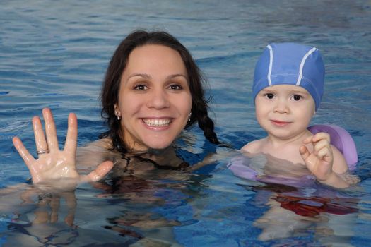 Mum with the son bathe in pool