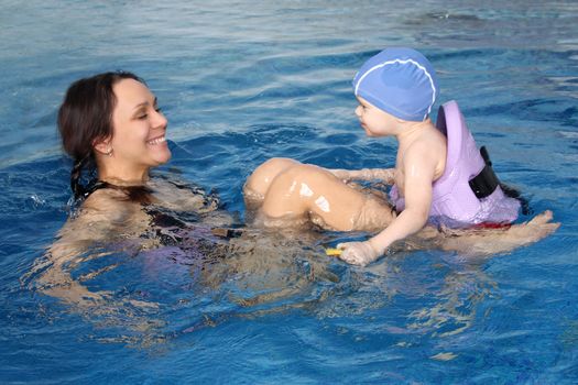 Mum with the son bathe in pool