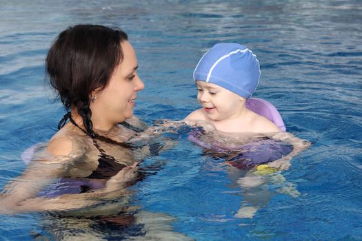 Mum with the son bathe in pool