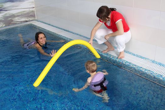 Mum with the son bathe in pool