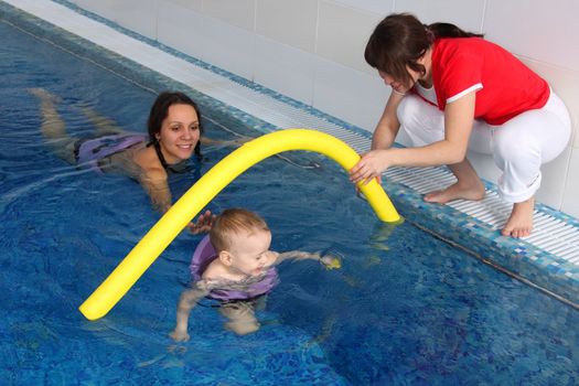 Mum with the son bathe in pool