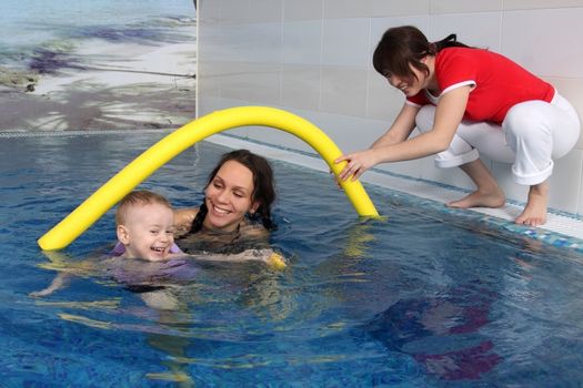 Mum with the son bathe in pool