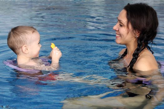 Mum with the son bathe in pool