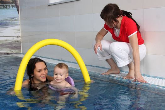 Mum with the son bathe in pool