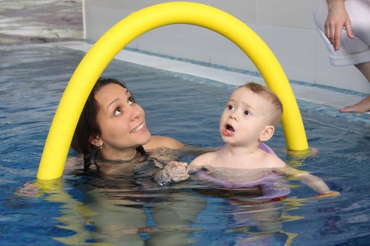 Mum with the son bathe in pool