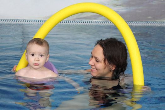 Mum with the son bathe in pool