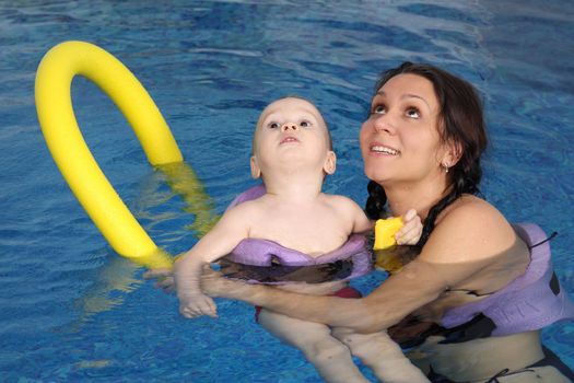 Mum with the son bathe in pool