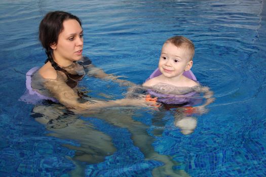 Mum with the son bathe in pool