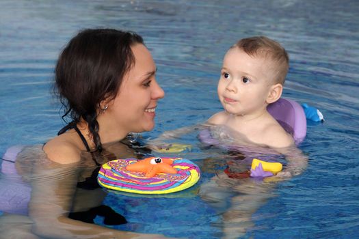 Mum with the son bathe in pool