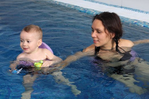 Mum with the son bathe in pool