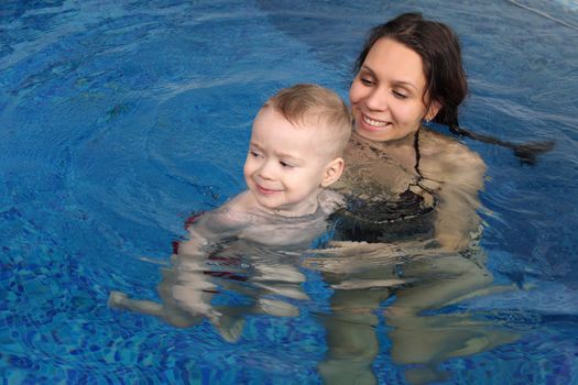 Mum with the son bathe in pool