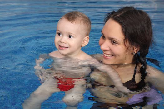 Mum with the son bathe in pool