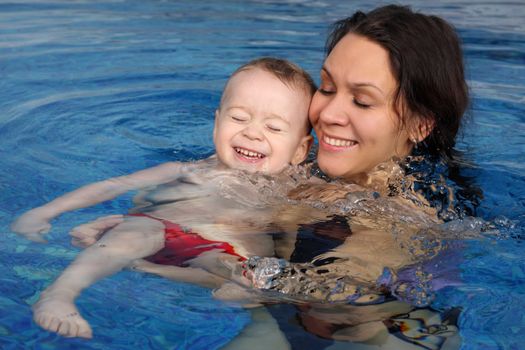 Mum with the son bathe in pool