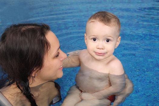 Mum with the son bathe in pool