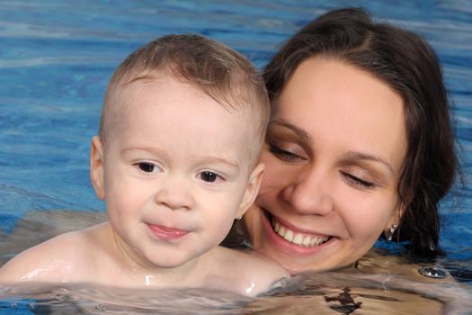 Mum with the son bathe in pool