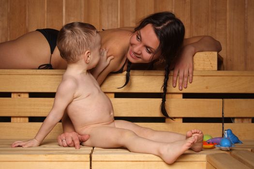 Mum with the small son are heated in a sauna
