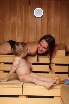 Mum with the small son are heated in a sauna
