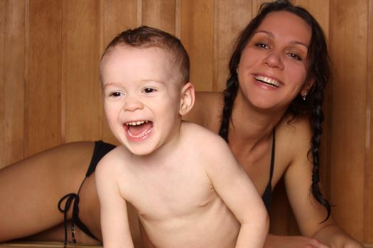 Mum with the small son are heated in a sauna
