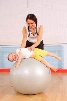 Mum with the son play a sports hall
