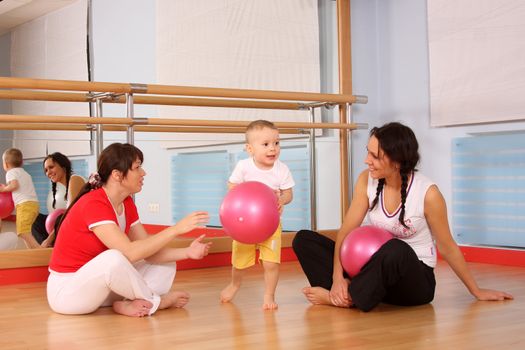 Mum with the son play a sports hall
