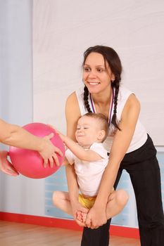 Mum with the son play a sports hall
