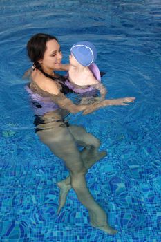 Mum with the son bathe in pool