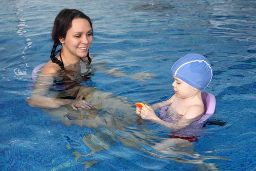 Mum with the son bathe in pool