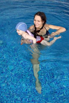 Mum with the son bathe in pool