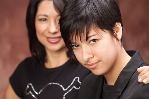 Attractive Multiethnic Mother and Daughter Studio Portrait.