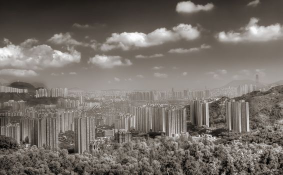 It is skyline with buildings near mountain in Hong Kong.