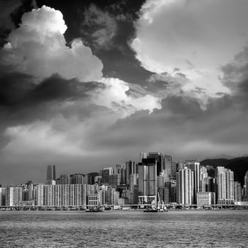 Dramatic Victoria Harbor scene with clouds in Hong Kong.