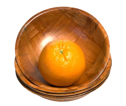A fresh orange sitting in a wooden bowl at the top of a stack, isolated against a white background