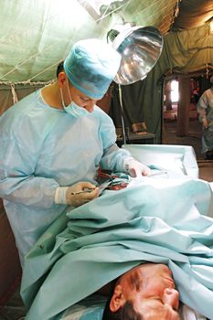 KYIV REGION, UKRAINE - MAY 24, : surgeons in operative room in military mobile hospital during a medical military trainings on May 24, 2007 in Kyiv region, Ukraine