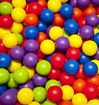 Background, colorful plastic balls on children's playground 