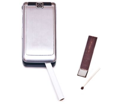 Cigarette with phone near box of matches isolated on the white