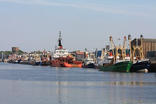 A group of fishing trawlers in a Dutch harbor