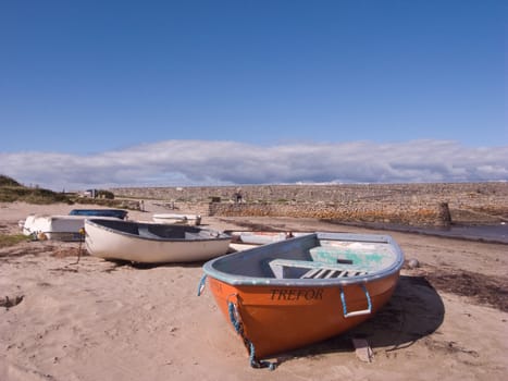 Old boats on the beach at Trefor, Wales UK.