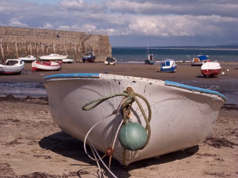 Boat with mooring buoy on Trefor Beach, Wales, UK