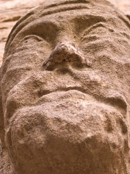 Ancient face carved out off sand stone.