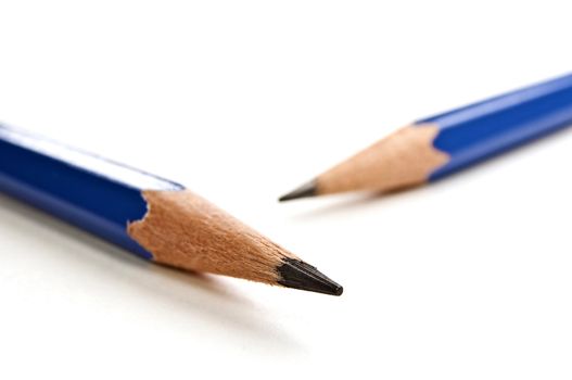 Sharp black pencils tips on white background.