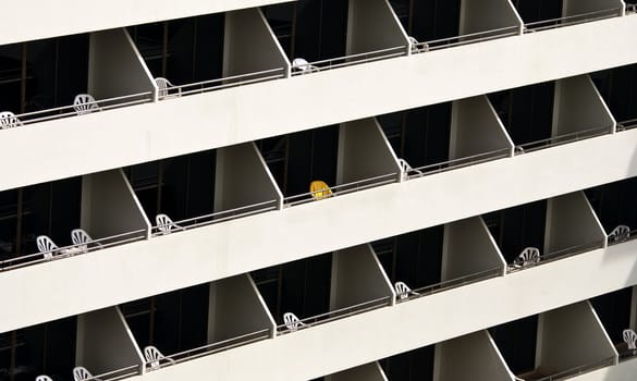 Hotel balconies with chairs on in the sun