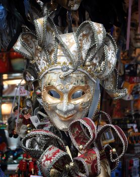Venetian mask is silver with gold details.