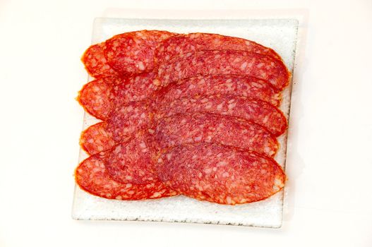 Salami  on the glass plate.