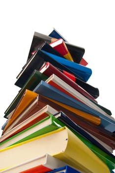 Books towering one over the other isolated on white