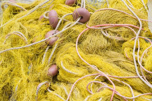 Tangled nylon yellow  fishing tackle close-up: net, float, cord