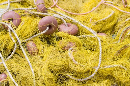 Tangled nylon yellow, fishing tackle close-up: net, float, cord