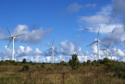 The wind generator on a background of the nature and the sky