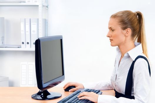 Woman works at the computer. Screen has a clipping path.