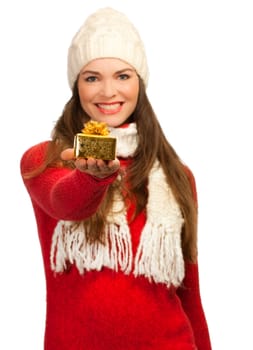 An isolated portrait of a beautiful young woman holding out a small christmas present. Focus on the present.