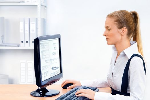 Woman works at the computer. Screen has a clipping path.